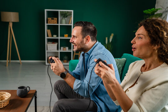 Happy couple enjoying leisure time playing video game