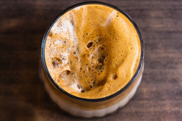 Close Up of Glass cup Coffee, Top Angle View. Wooden table and place for text.