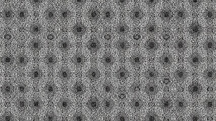 A pattern of evenly spaced black dots on a gray textured background arranged in a grid formation.