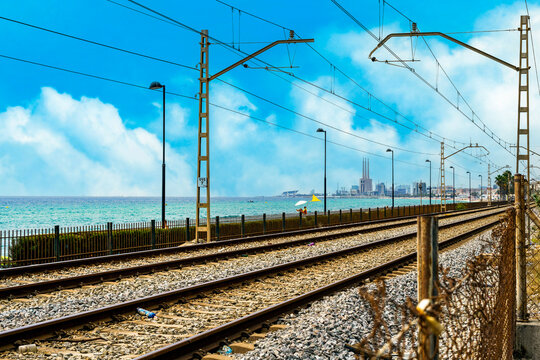 Railway tracks, beach and thermal power plant in Badalona, Spain