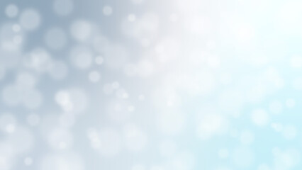 Christmas bokeh light background of soft, blurred, white glowing circles on a gradient blue-grey to white festive atmosphere