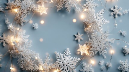 circular arrangement of white snowflakes and star decorations with warm fairy lights on a soft blue background