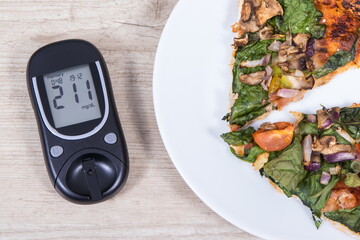 Glucose meter for sugar level control and piece of vegetarian pizza. Nutrition and eating fast food during diabetes