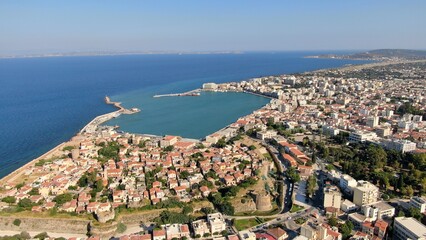 Naklejka premium Aerial drone view of the main port of Chios, Greece. Ferries, harbor infrastructure, waterfront urban landscape and clear Aegean waters. High-resolution Mediterranean maritime and travel photography.