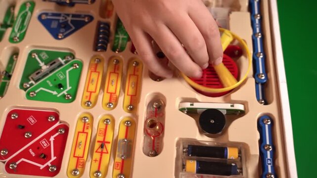 Schoolchildren build electric circuits using a hands-on construction kit