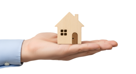 hand gently holding a small wooden house model, isolated on white background