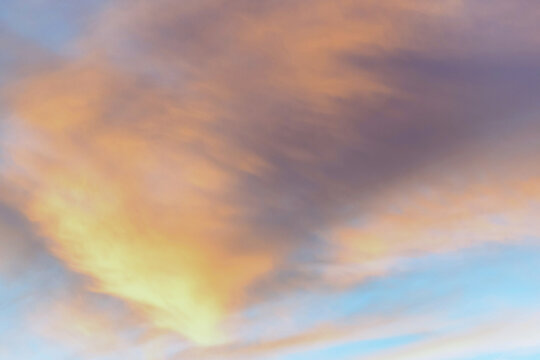 Twilight sky with effect of light in pastel pink, coral, orange, blue tones. Colorful sunset of soft clouds. Background