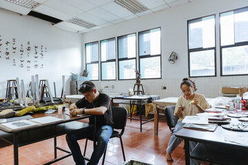 Young students focusing on their art projects, learning new skills and expressing creativity in an art workshop setting