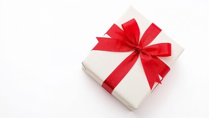 A neatly wrapped gift with textured white paper and a bright red satin ribbon on a blank background.