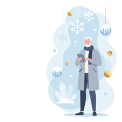 Stylish senior man in a winter coat uses a digital tablet near festive snowflakes and gold ornaments