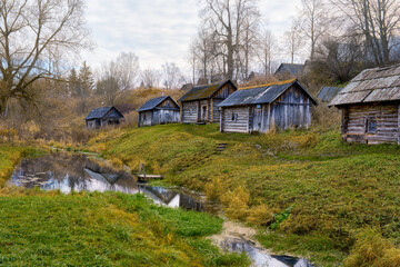 Old wooden bathhouses by the river in the village of Vyatskoye.