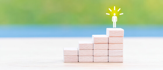 Motivational setup with wooden blocks forming steps toward glowing figure symbolizing success and achievement in bright, blurred background