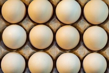 Brown and white eggs arranged on market counter. Local farm fresh eggs sold at outdoor market. Organic farm eggs for sale at farmers market.
