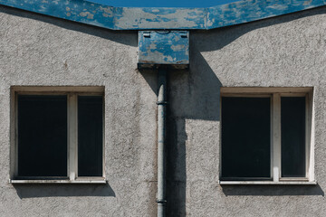 Symmetrical Old Building Facade with Two Dark Windows