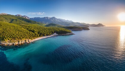 stunning aerial view of a serene coastline with lush green forests clear turquoise waters and majestic mountains in the background during golden hour light