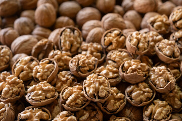 Organic walnuts for sale at street market. Close-up of walnuts in traditional market. Fresh shelled walnuts on market stall.