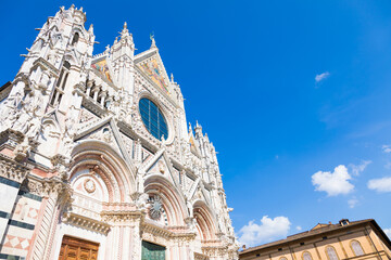 Obraz premium Siena cathedral in Italy. White marbles with blue sky, famous landmark of Tuscany.