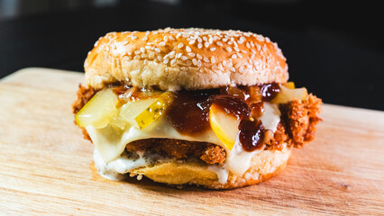 Korean fried chicken katsu burger with panko-crusted thigh, brioche bun, special sauces, pickles, and cheese. Crispy, juicy, and packed with flavor. Asian fusion delight.