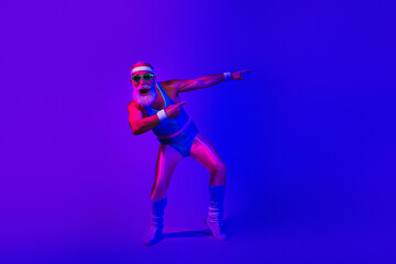 Obraz premium Vibrant retro fitness portrait of a bearded man in a jumpsuit striking a dynamic disco pose under purple blue neon lights