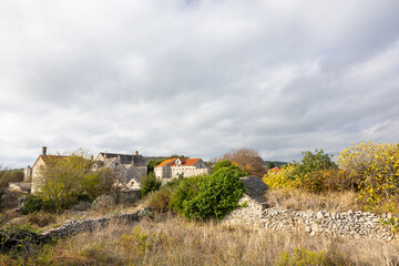 Charming Stone Village With Old Houses And Dry Stone Walls Under Cloudy Sky