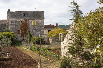 Rustic Stone Building With Green Shutters Overlooking Garden And Clear Blue Sky, Grohote, Solta