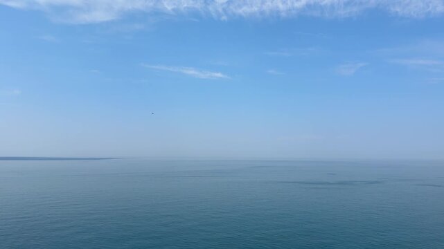 Calm sea with still water and clear sky in morning.