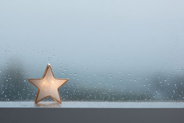 solitary star shines brightly on snowcovered window creating magical atmosphere