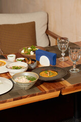 A Delicious Array of Colorful Dishes Displayed Beautifully on a Wooden Table Setting