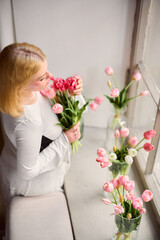Gentle woman carefully crafts tulip bouquet in peaceful setting