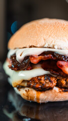 Juicy burger with special rub, melted cheese, onion chutney, and crispy bacon. Perfectly cooked and succulent, ideal for gourmet meals and promotions.
