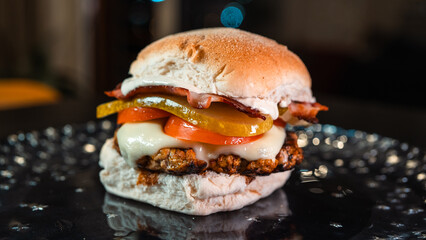 Juicy burger with special rub, melted cheese, onion chutney, crispy bacon, gherkins, and tomato slices. Perfect comfort food for gourmet meals and promotions.