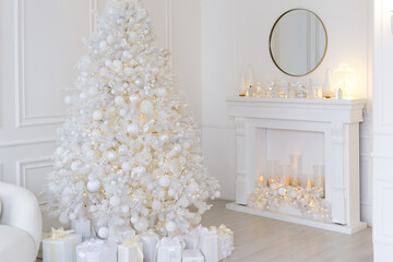 White Christmas interior with decorated tree, glowing garlands, candles, white gifts, elegant festive decor, and a round mirror above a white fireplace.