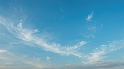 Clear sky with wispy clouds and blue hues.
