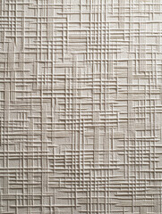 Beige embossed geometric wall texture with intersecting linear patterns