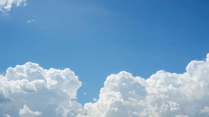 Clear blue sky with fluffy white clouds. © Lasvu