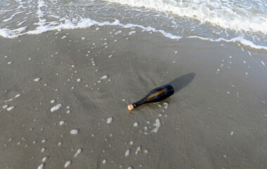bottle found on the beach sealed with a cork containing a secret message or a treasure map