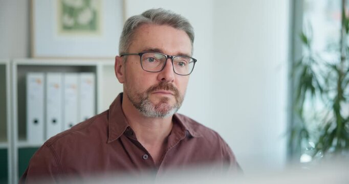 Employee, thinking and man with computer, reading and economist with research on website and online. Office, serious and mature person with tech for inflation rates, reflection and financial analysis