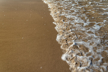 Ocean Wave Washing Over Sand Beach