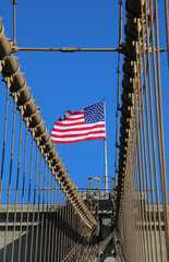 american flag stars and stripes on the brooklyn bridge among the cables an iconic symbol of nyc and america