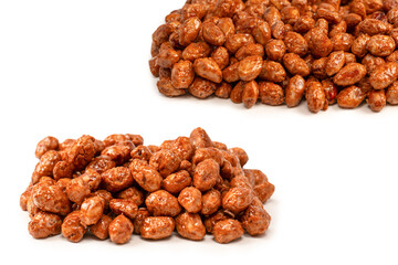 Tasty sweet roasted peanuts isolated on a white background.