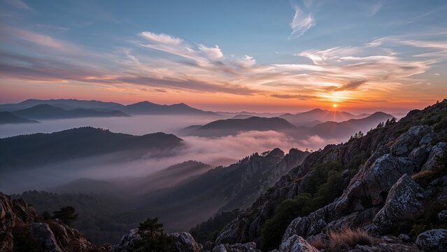 A scenic view of mountains and clouds at sunrise with a colorful sky. - Powered by Adobe