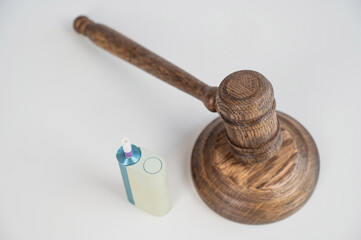Judge's gavel and electronic cigarette. Smoking ban. Tobacco heating systems. 