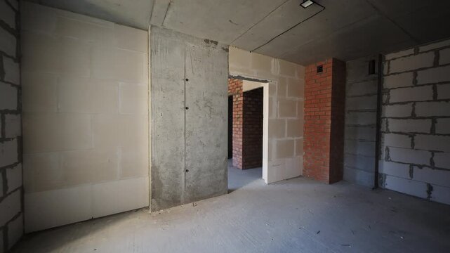 Unfinished apartment interior with concrete and block walls