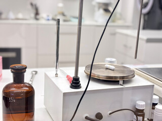 close up of a scientific balance weighing a white capsule pill Ozempik next to an amber glass bottle in a pharmacy lab concept of pharmacology, compounding, precise measurement