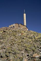  Sunlit Stone Tower on Gaustatoppen in Telemark Amidst a Serene Summer Skyscape Keywords: Gaustatoppen, stone building, tower, sunny, summerday, blue sky, Telemark, rocky top, mountain peak, Norway,