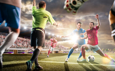 Soccer players in action on the sunset stadium background. Panorama. Sports concept. Football players. The decisive match. Soccer championship.