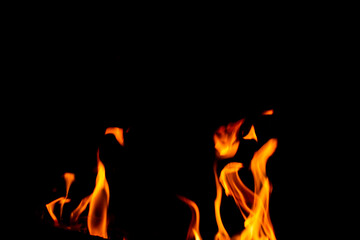 Texture of natural fire at night, on a black background.