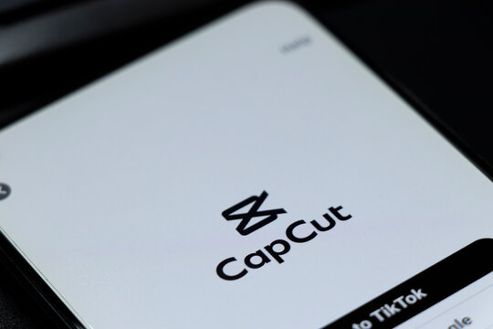 Warsaw, Poland - November 13, 2025: Close-up of CapCut application logo displayed on a smartphone screen, showcasing video editing capabilities for social media platforms.