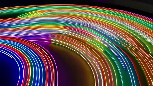 This vibrant video features a dynamic display of colorful light trails swirling and intertwining against a dark background. The mesmerizing motion creates an energetic atmosphere that captivates the v