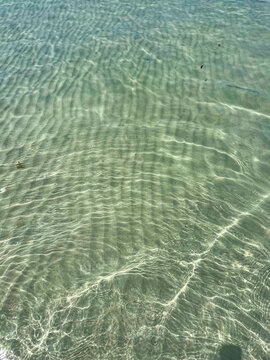 Transparent clear water on a white sand beach